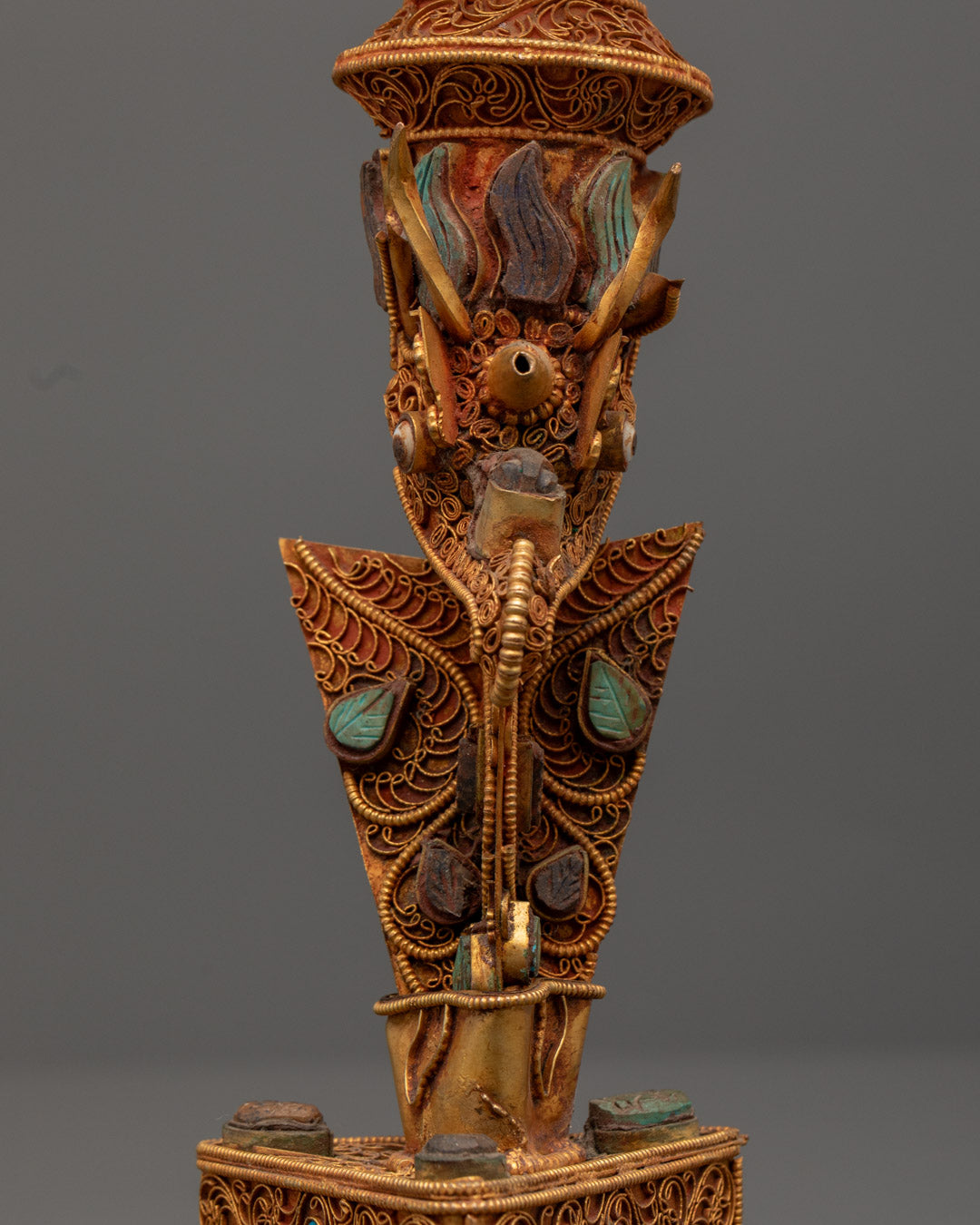 Rear view of ritual Phurba highlighting crystal structure and symbolic copper carvings