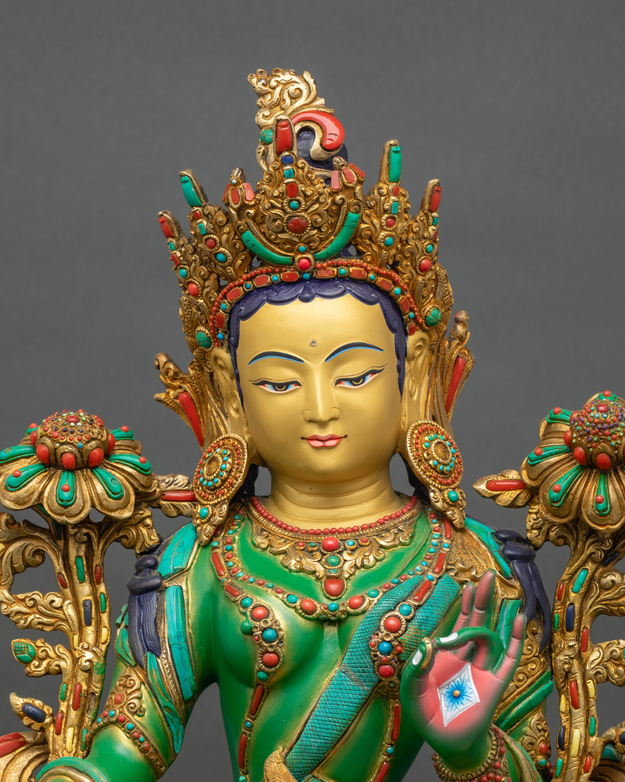 Regular close-up of Green Tara Droljang statue showing detailed copper and gold finish