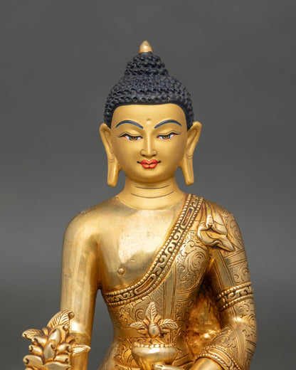 Regular close-up of Medicine Buddha statue showing intricate copper and gold details