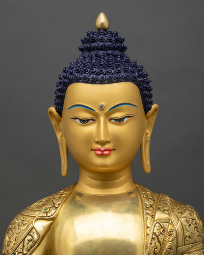 Regular close-up of Shakyamuni Buddha sculpture showing intricate gold and copper details
