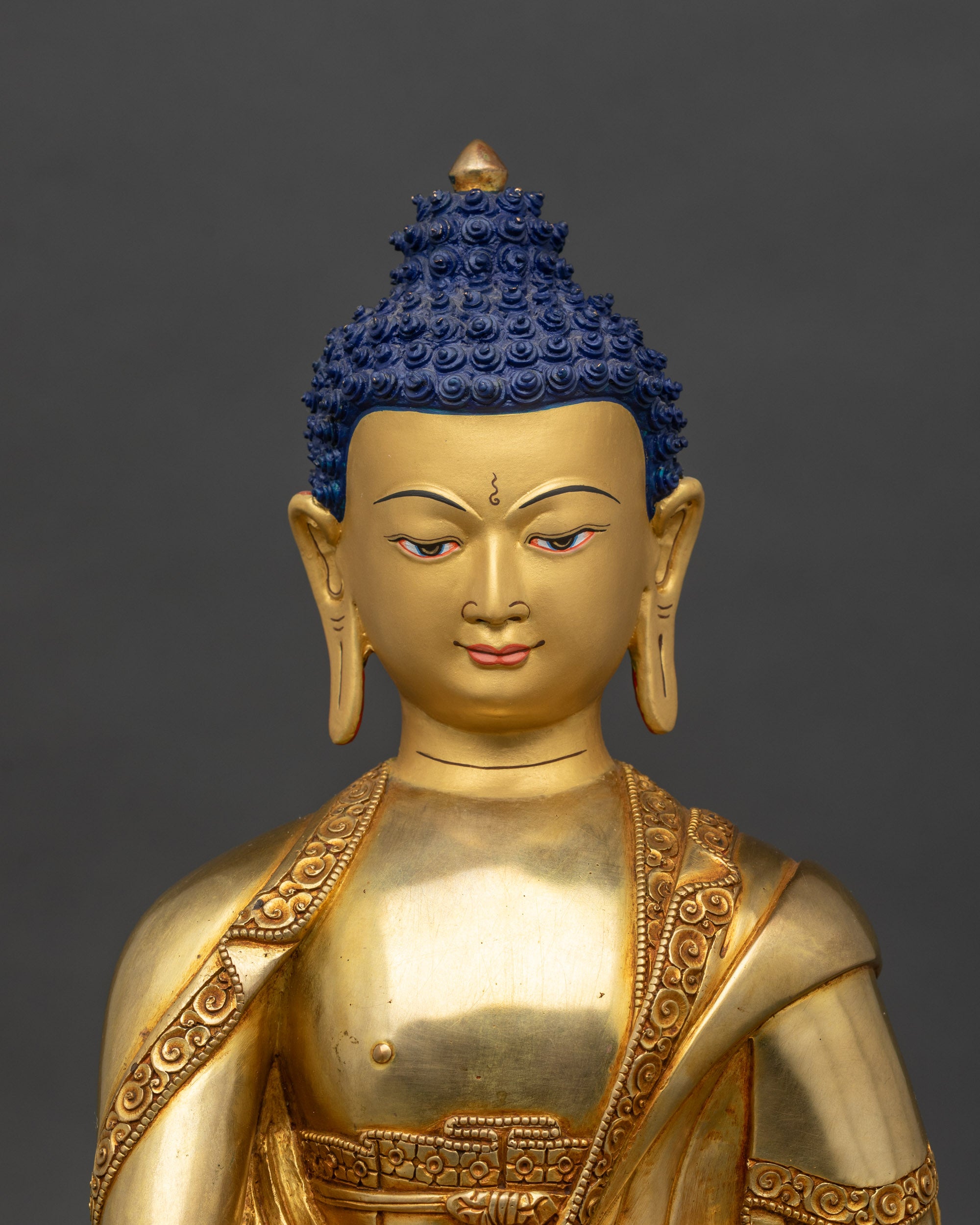Regular close-up of Shakyamuni Buddha statue showing Bhumisparsha mudra and lotus pedestal