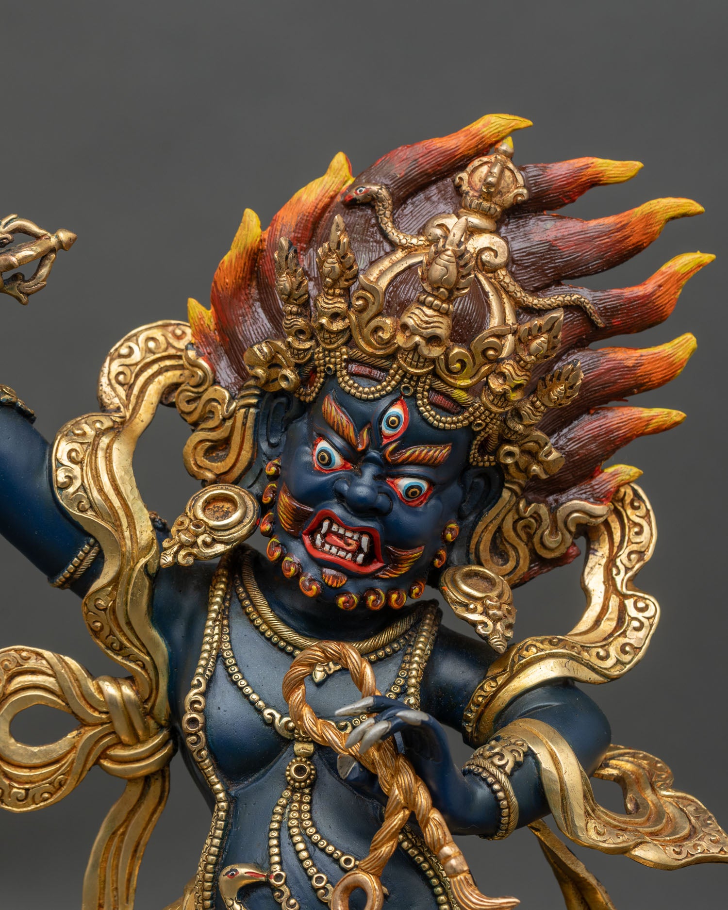 Regular close-up of Vajrapani Bodhisattva statue showing intricate copper and gold details