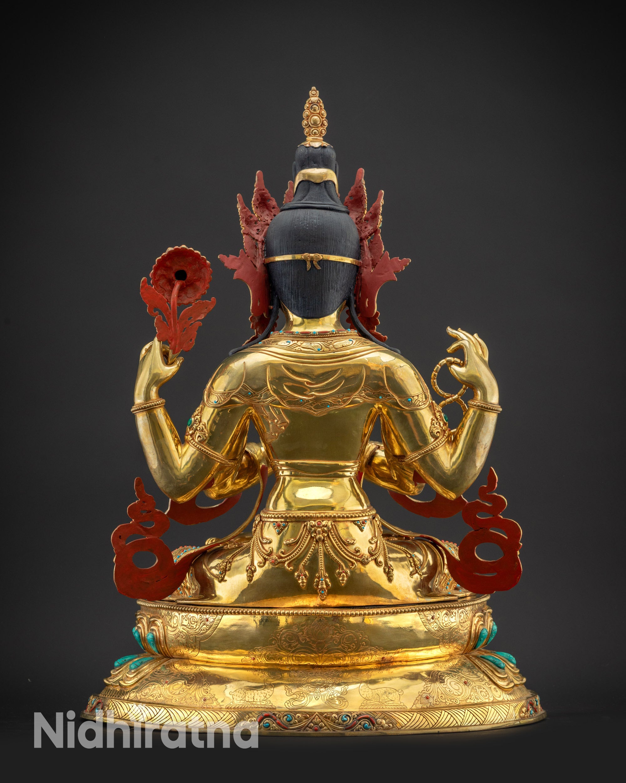 Regular back view of Chenrezig Statue with dharma wheel and pair of deers carved on lotus
