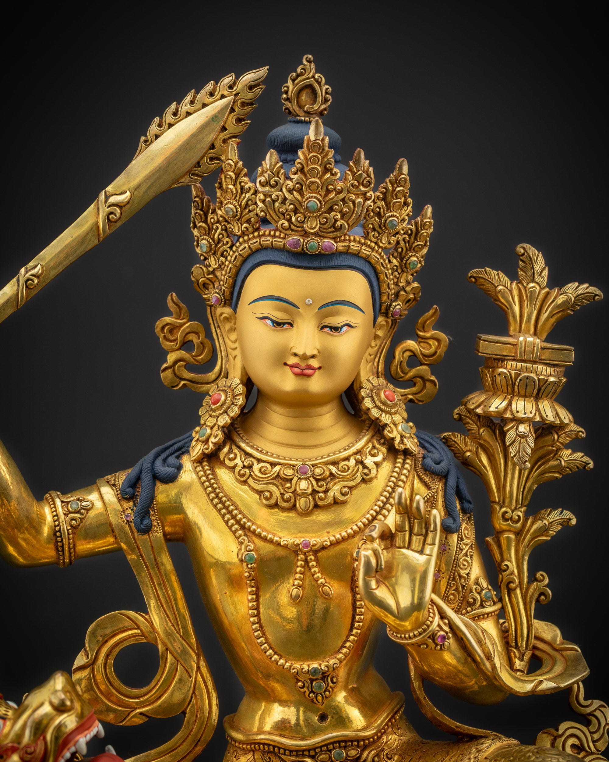 Regular close-up of Arapacana Manjushri Buddhist sculpture showing jeweled crown and ornaments