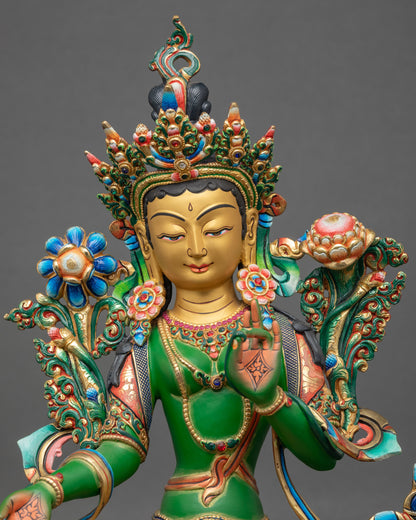 Regular close-up of Green Tara sculpture showing thangka-inspired painted copper details
