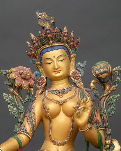 Regular close-up of Green Tara sculpture showing yellow body and floral robe details