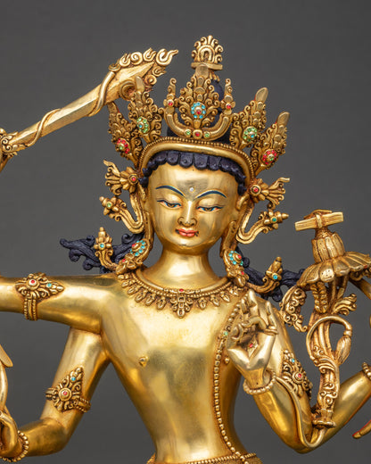 Regular close-up of Maha Manjushri figurine showing detailed copper and gold patterns