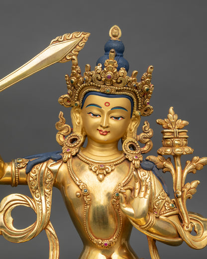 Regular close-up of Manjushri Sculpture showing intricate copper and gold detailing