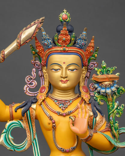 Regular close-up of Manjushri sculpture showing detailed floral robes and lotus pedestal