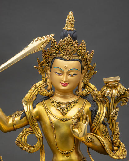Regular close-up of Manjushri statue showing detailed robes and lotus seat