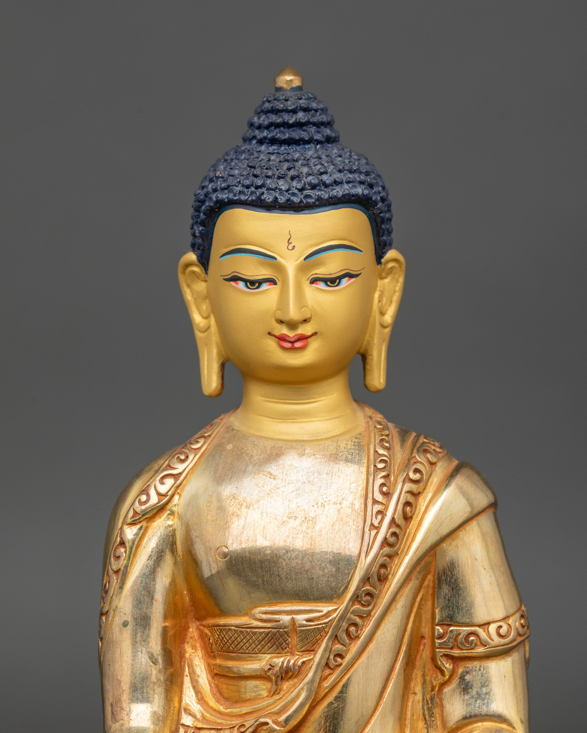 Regular close-up of Ratnasambhava statue showing intricate copper and gold craftsmanship