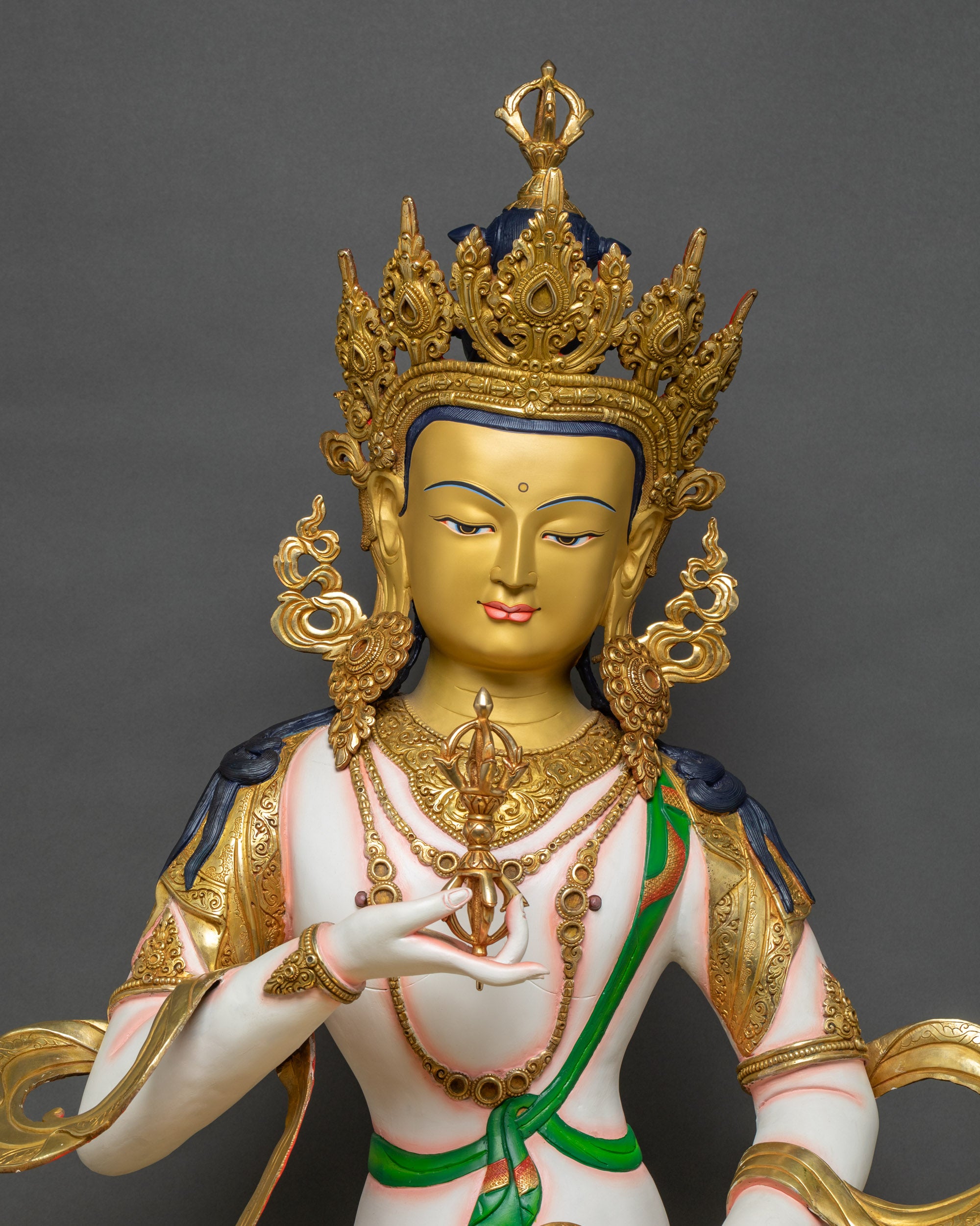 Regular close-up of Vajrasattva sculpture showing intricate lotus seat and gilded details