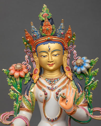 Regular close-up of White Tara sculpture showing detailed floral robes and lotus pedestal
