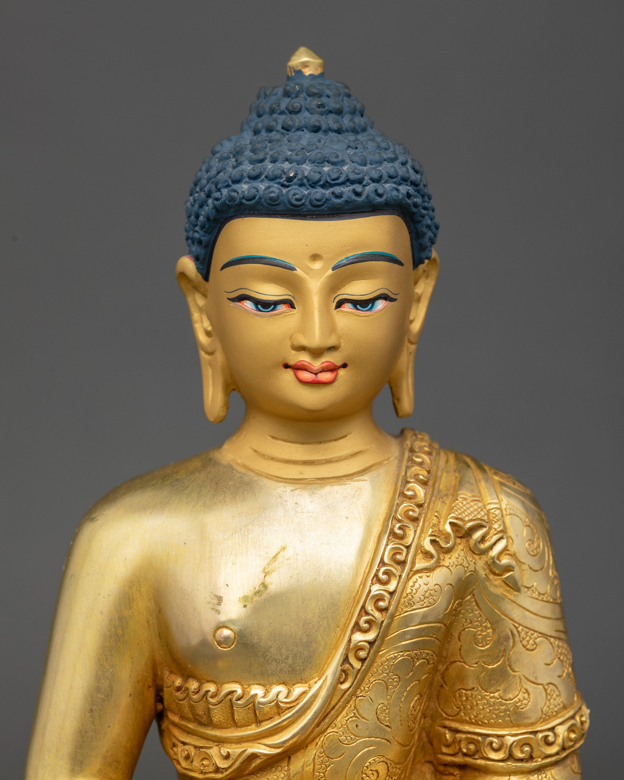 Regular close up: Amitabha Buddha Statue close-up view gold-painted copper details