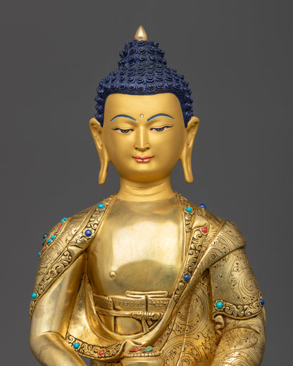 Regular close up Amitabha Buddha gold-gilded meditation statue showing serene details