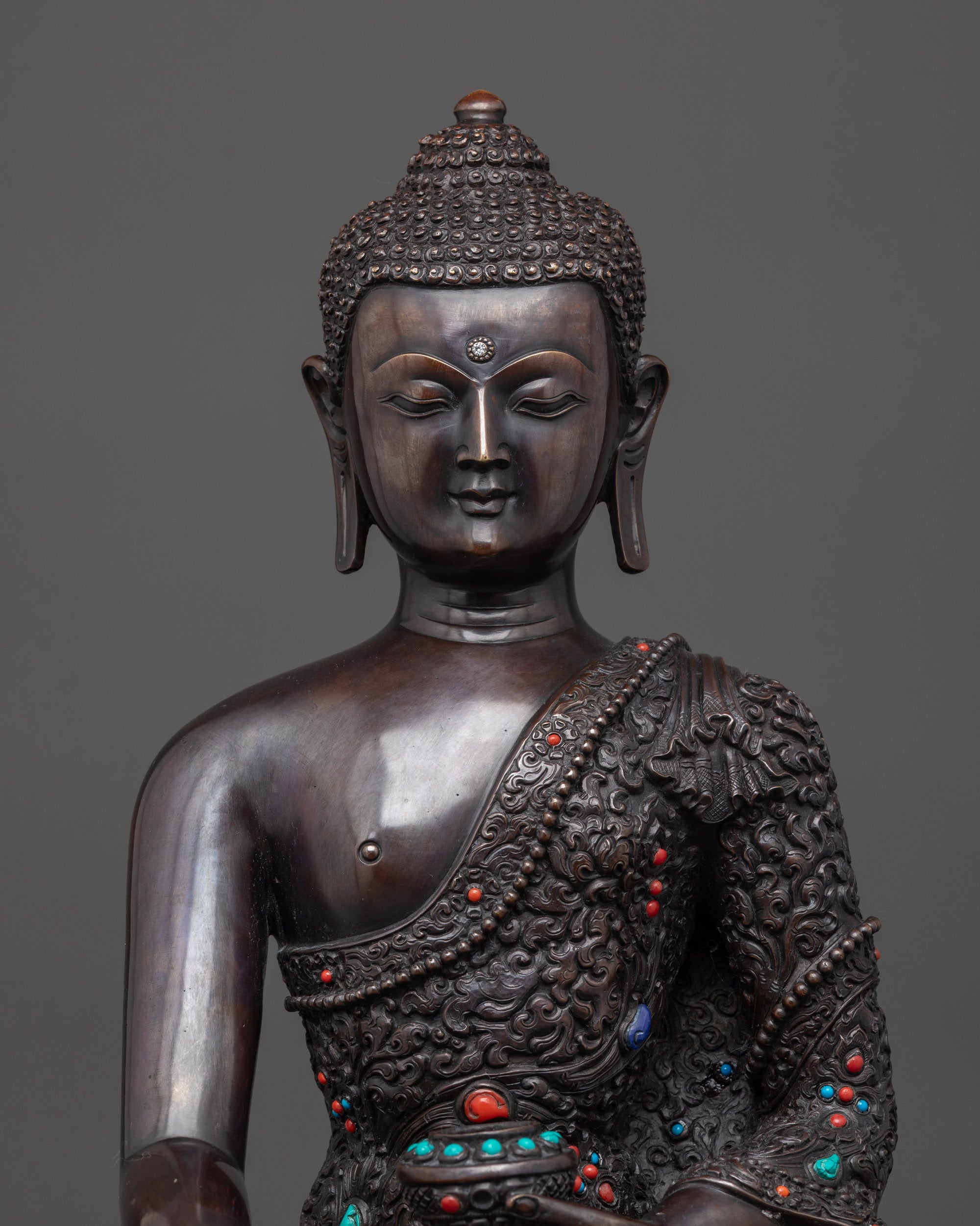 Regular close up Buddha Shakyamuni oxidized statue highlighting semi-precious stones
