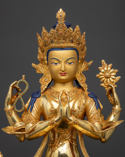 Regular close up Chenrezig sculpture showing detailed swirling robe and sacred objects