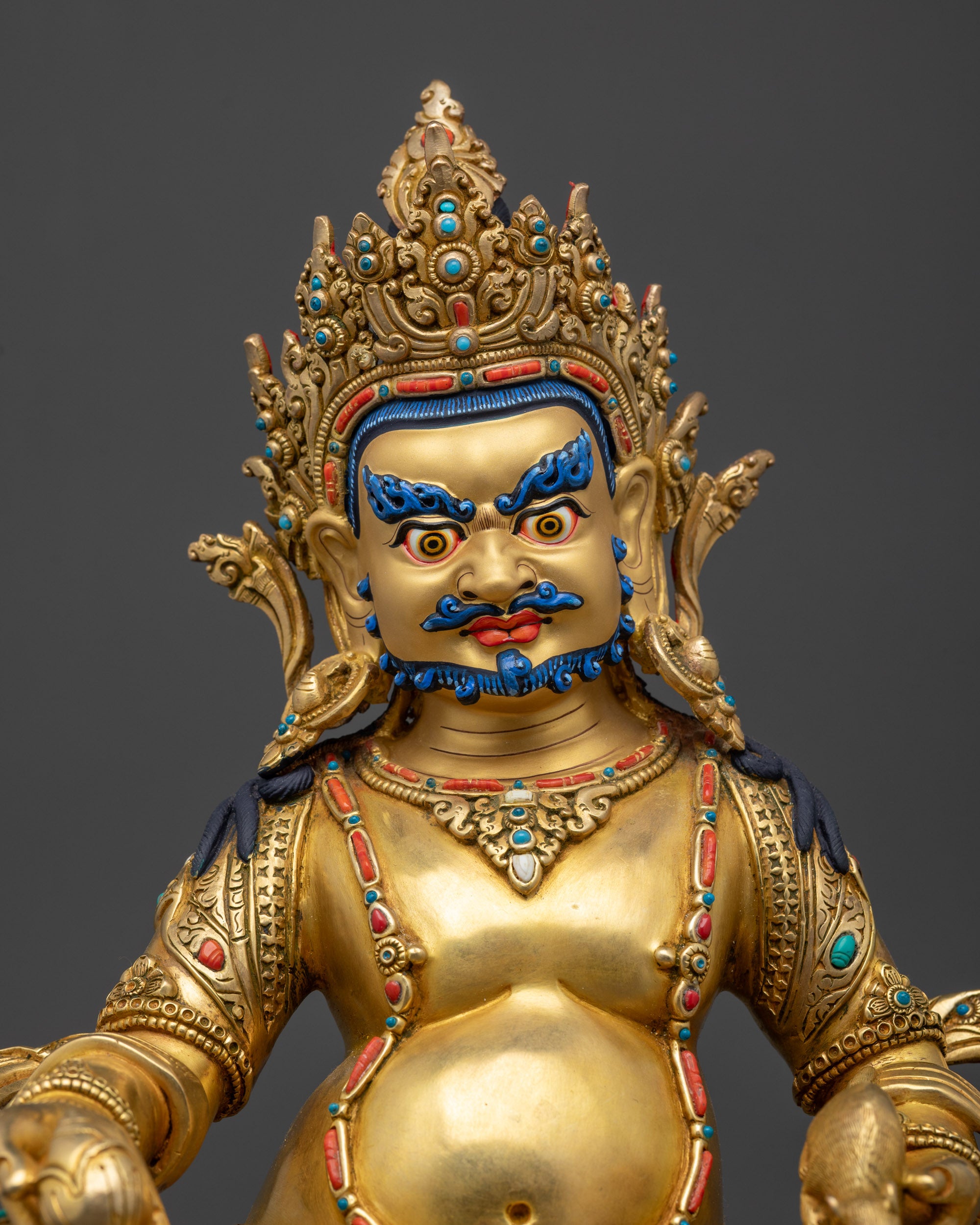 Regular close up Dzambhala Statue showing wrathful gold-gilded face and jewelry details