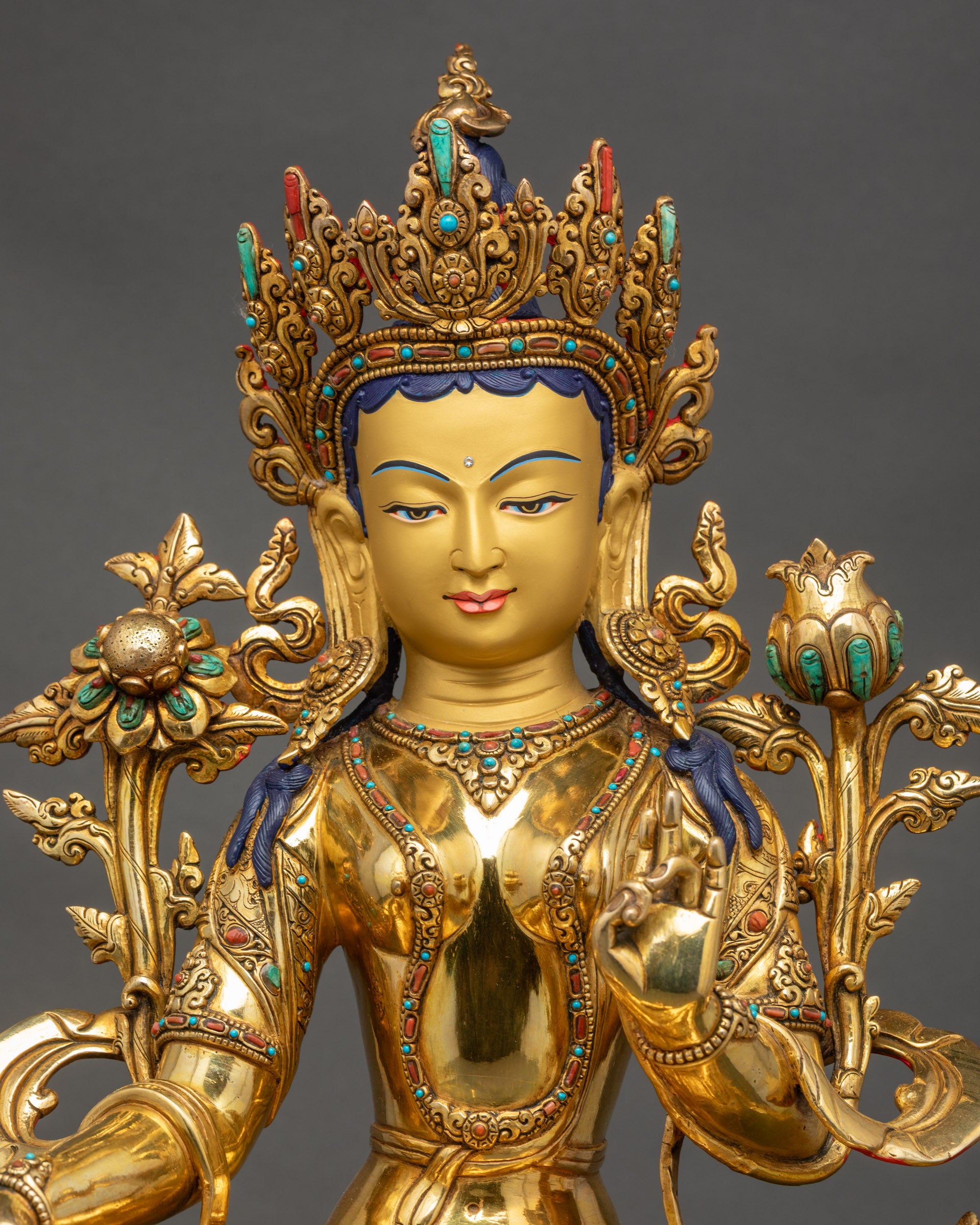Regular close up Green Tara Bodhisattva sculpture showing gold-gilded face and crown details