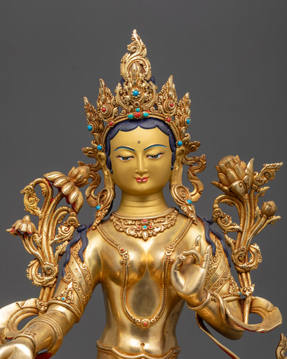 Regular close up Green Tara Statue with flowing robes and Utpala flower in left hand
