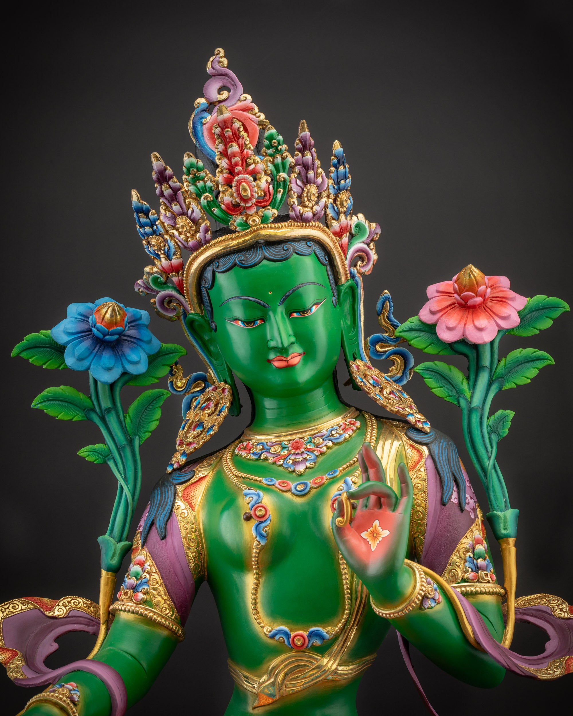 Regular close up Green Tara statue face serene expression with crown front