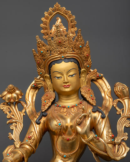 Regular close up Green Tara statue holding utpala flower beside her shoulder gracefully
