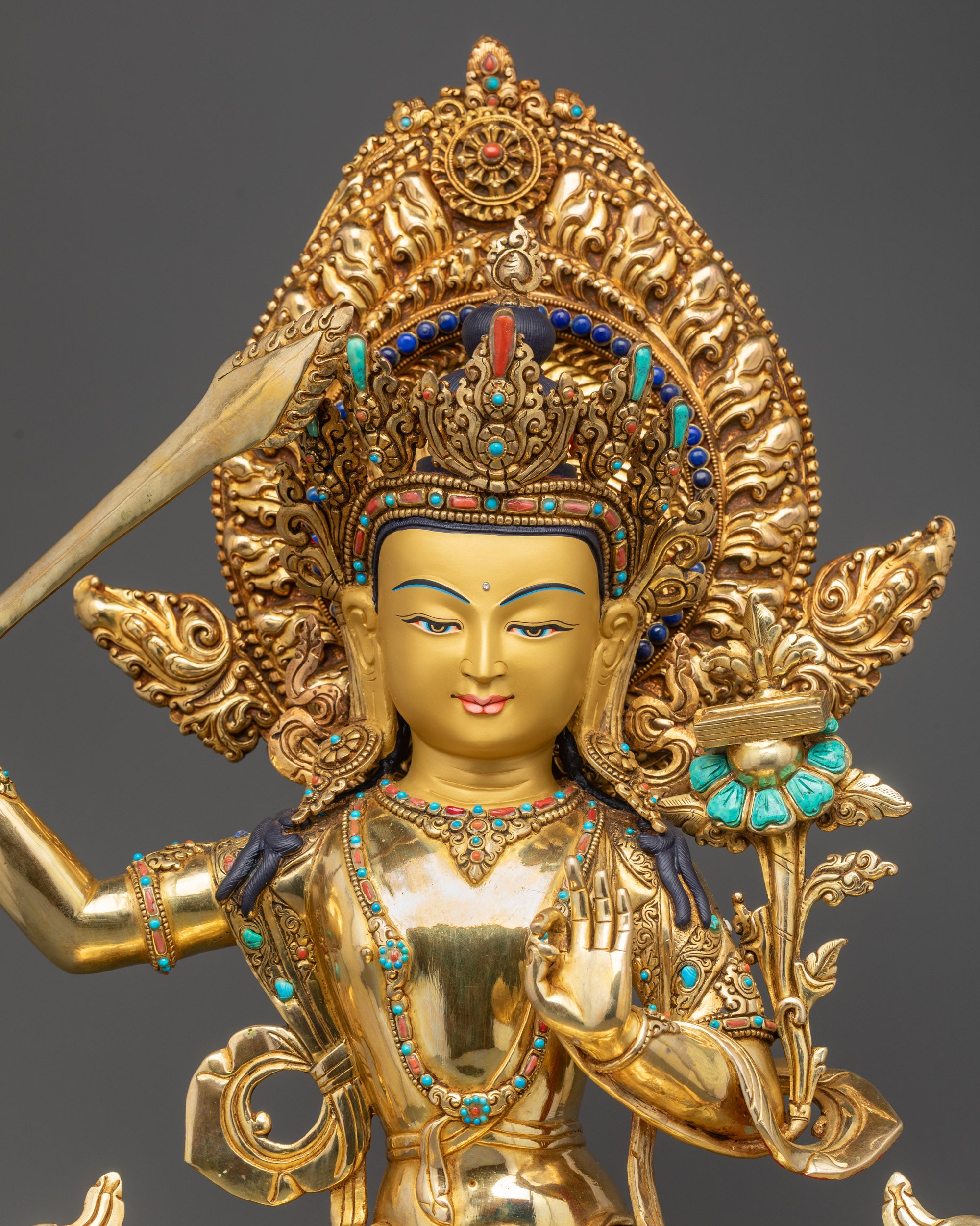 Regular close up Manjushri Statue showing intricate robes and gold fire-gilded finish
