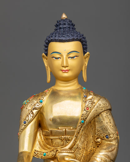 Regular close up Shakyamuni Buddha statue showing serene posture and detailed robe