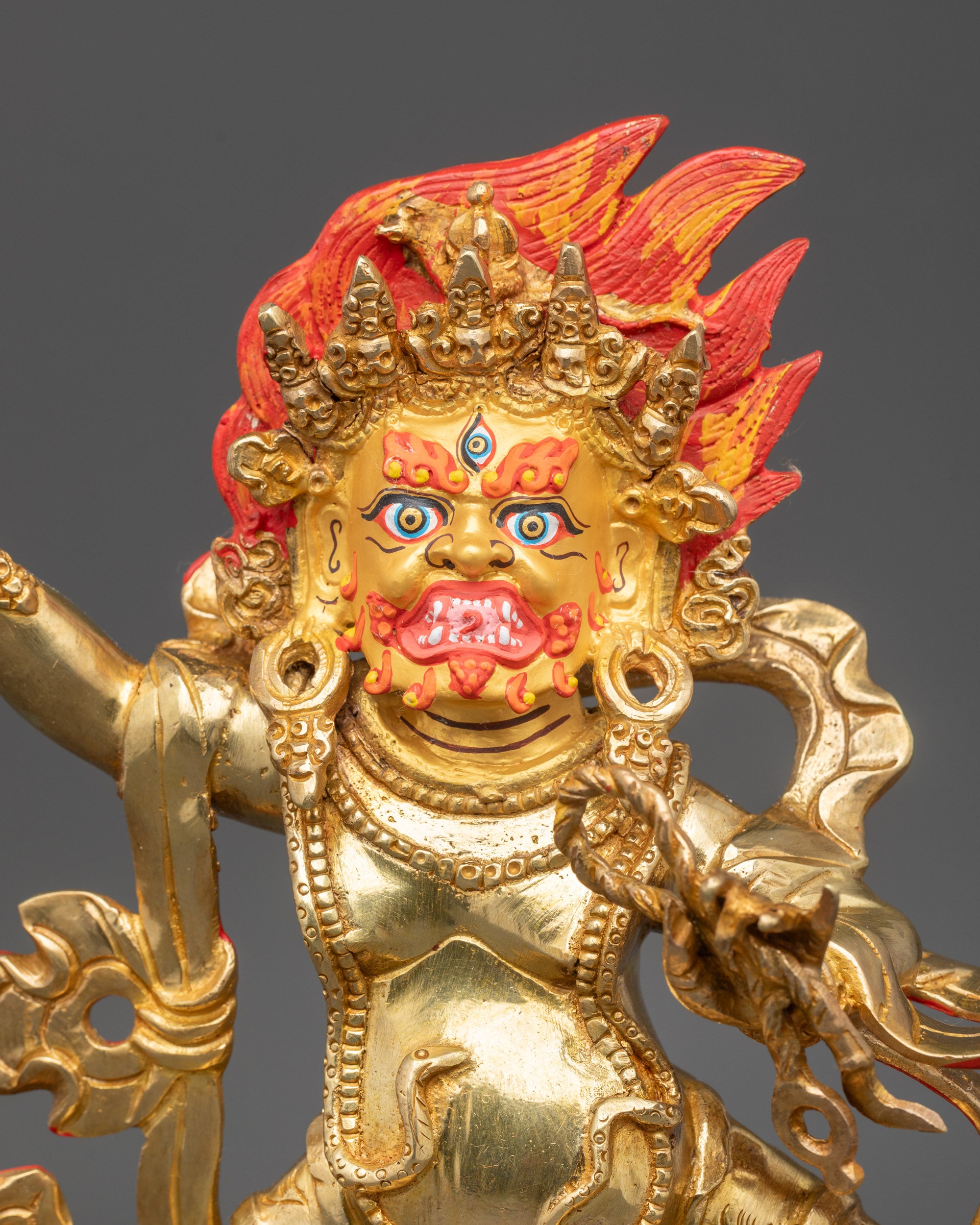Regular close up Vajrapani Statue gold-gilded face wrathful expression third eye
