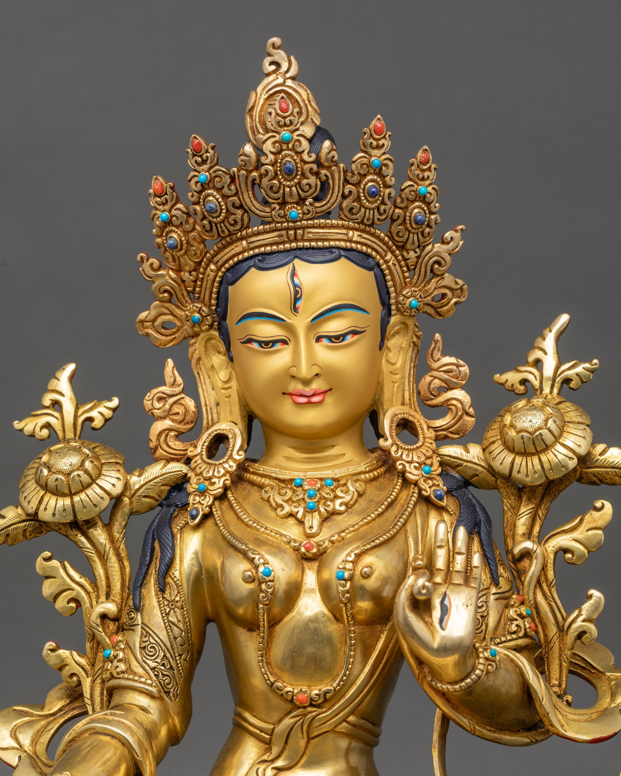 Regular close up White Tara statue showing semi-precious stones on crown and robe
