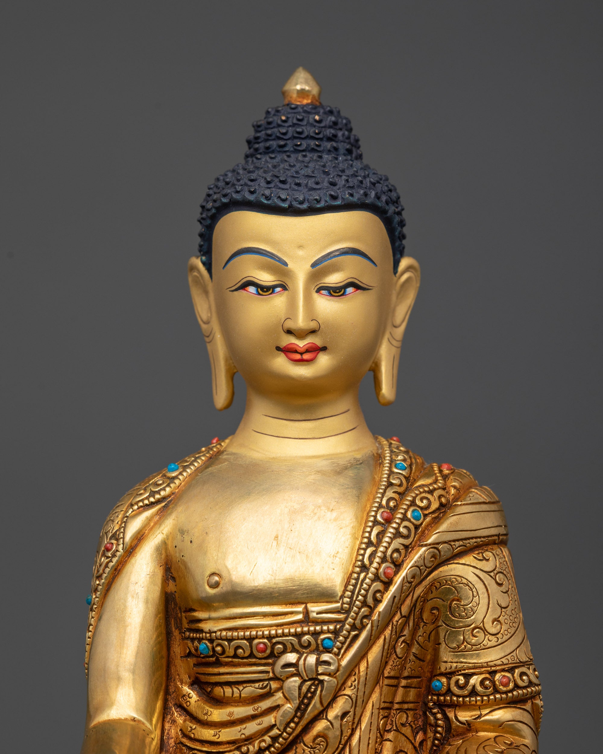 Regular close up of Bodhi Shakyamuni Buddha showing semi-precious stones on robe
