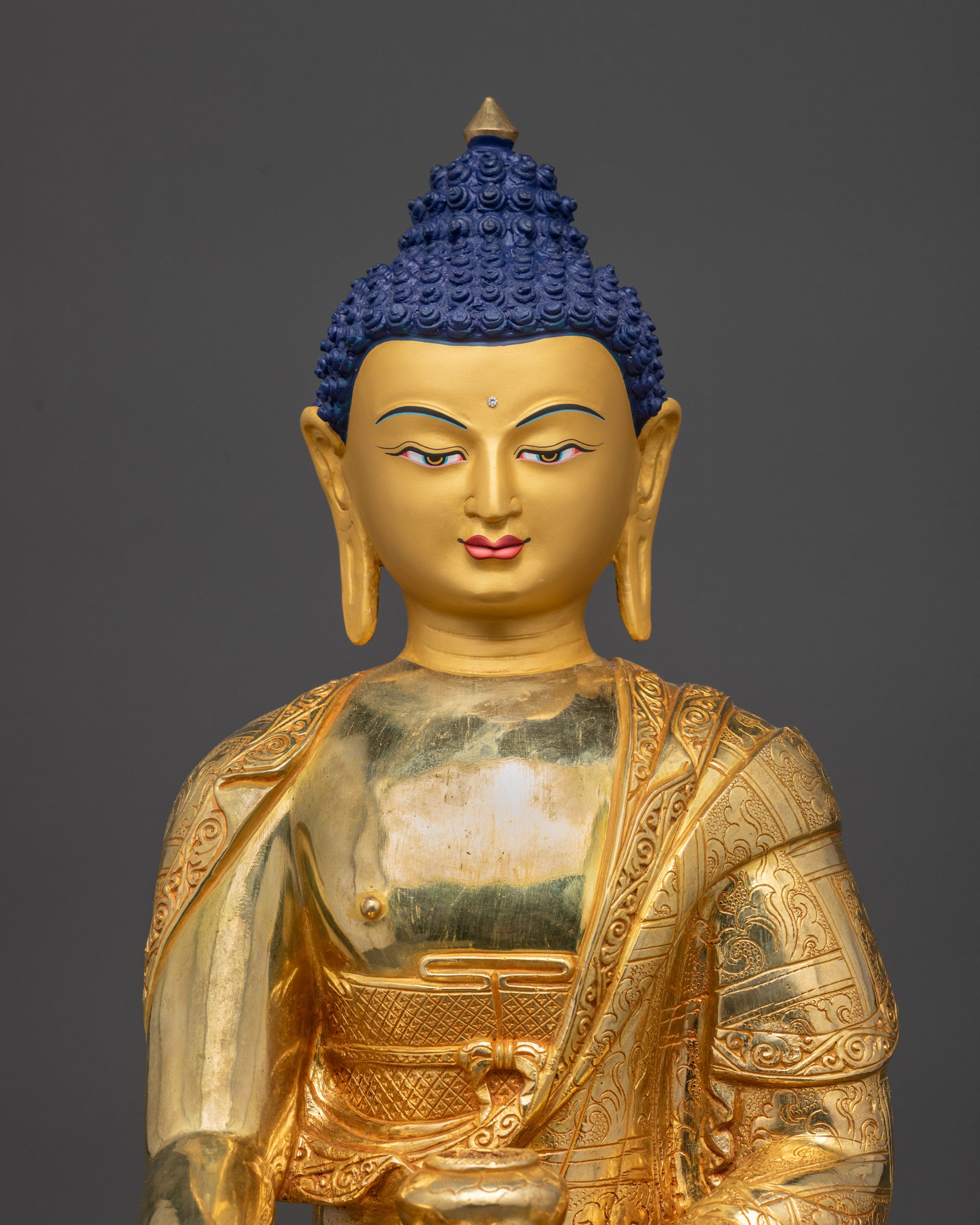 Regular close up of Buddha robe and intricate patterned garments
