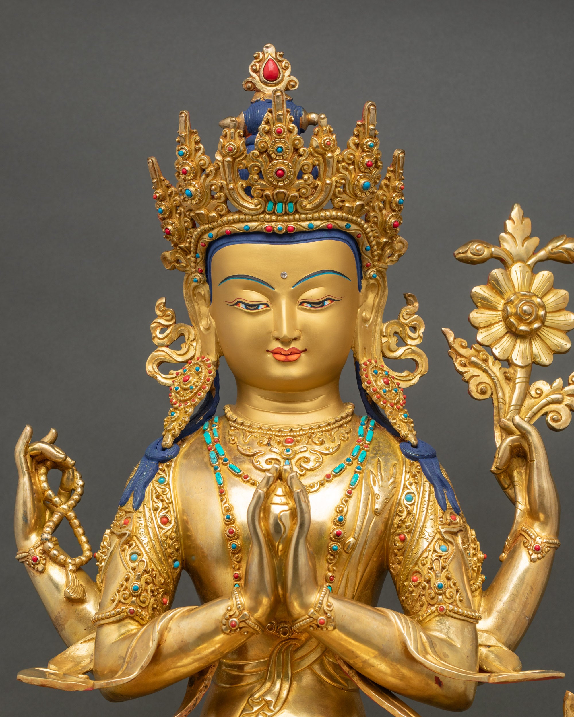 Regular close up of Chenrezig Bodhisattva sculpture showing intricate gold fire-gilded details