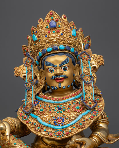 Regular close up of Dzambhala statue highlighting crown, necklace, and gemstone details
