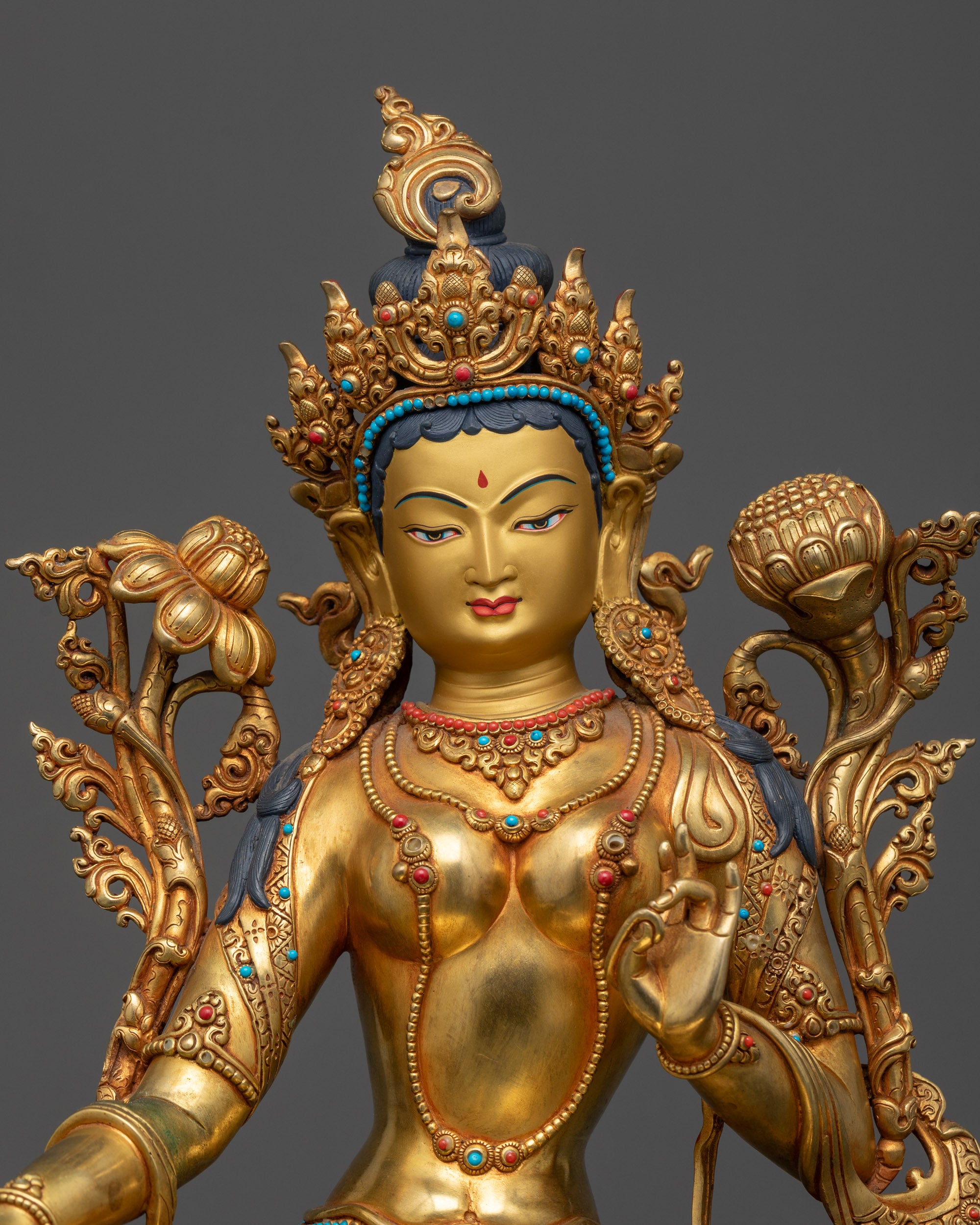 Regular close up of Green Tara Statue highlighting flowing robes and lotus flower
