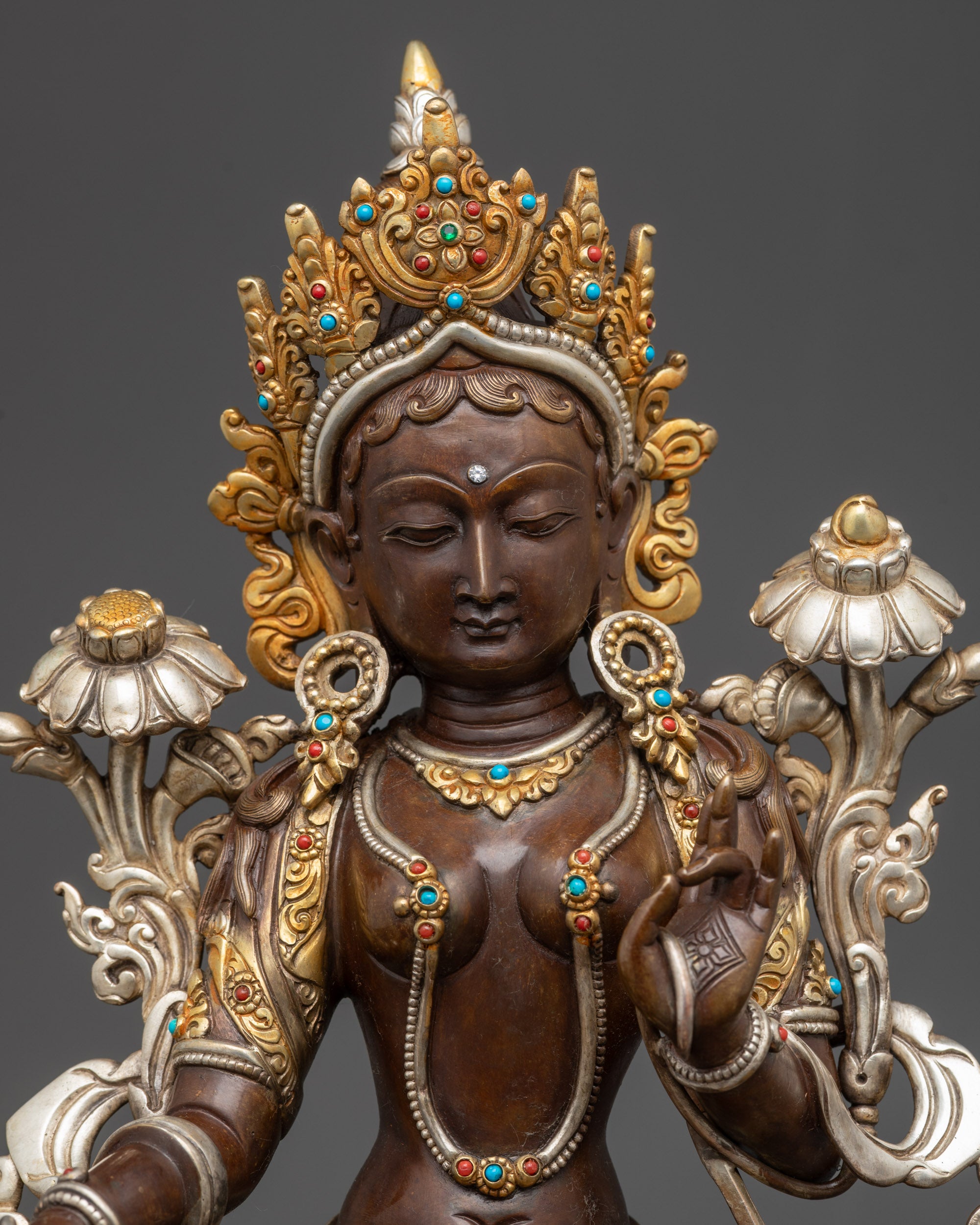 Regular close up of Green Tara Statue showing gold-plated robe and semi-precious stones
