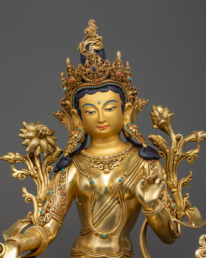 Regular close up of Green Tara holding utpala flower with flowing robes
