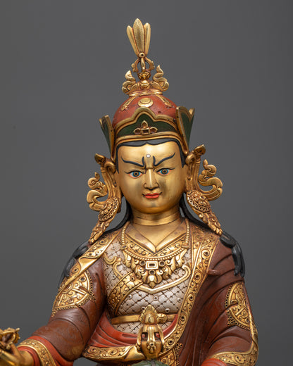 Regular close up of Guru Rinpoche holding khatvanga trident and skull cup for tantric blessings
