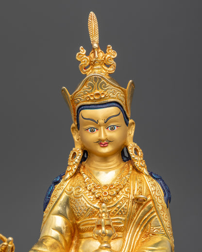 Regular close up of Guru Rinpoche statue showing kasaya robe and lotus hat