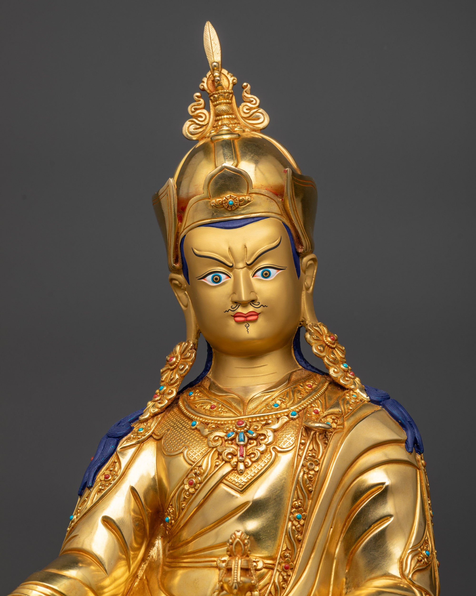 Regular close up of Guru Rinpoche statue showing wrathful yet compassionate face
