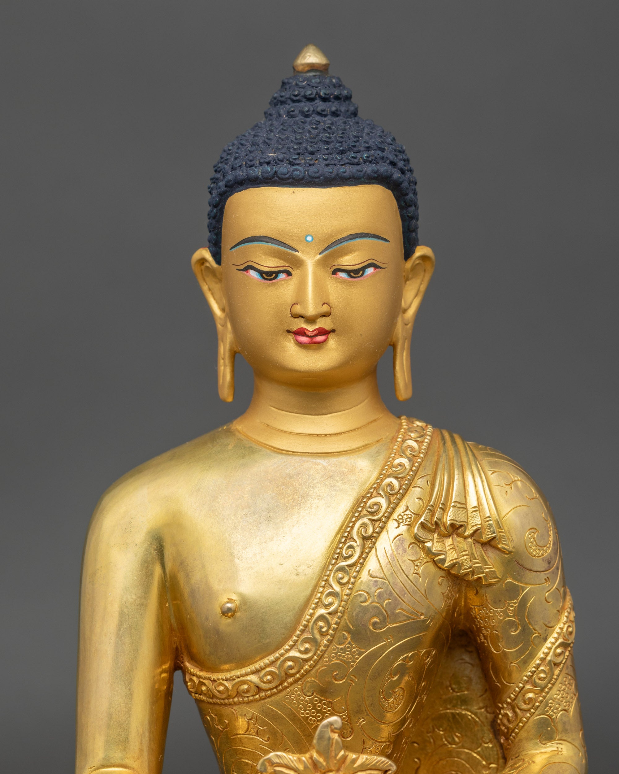 Regular close up of Healing Buddha Bhaisajyaguru Statue showing intricate gold details