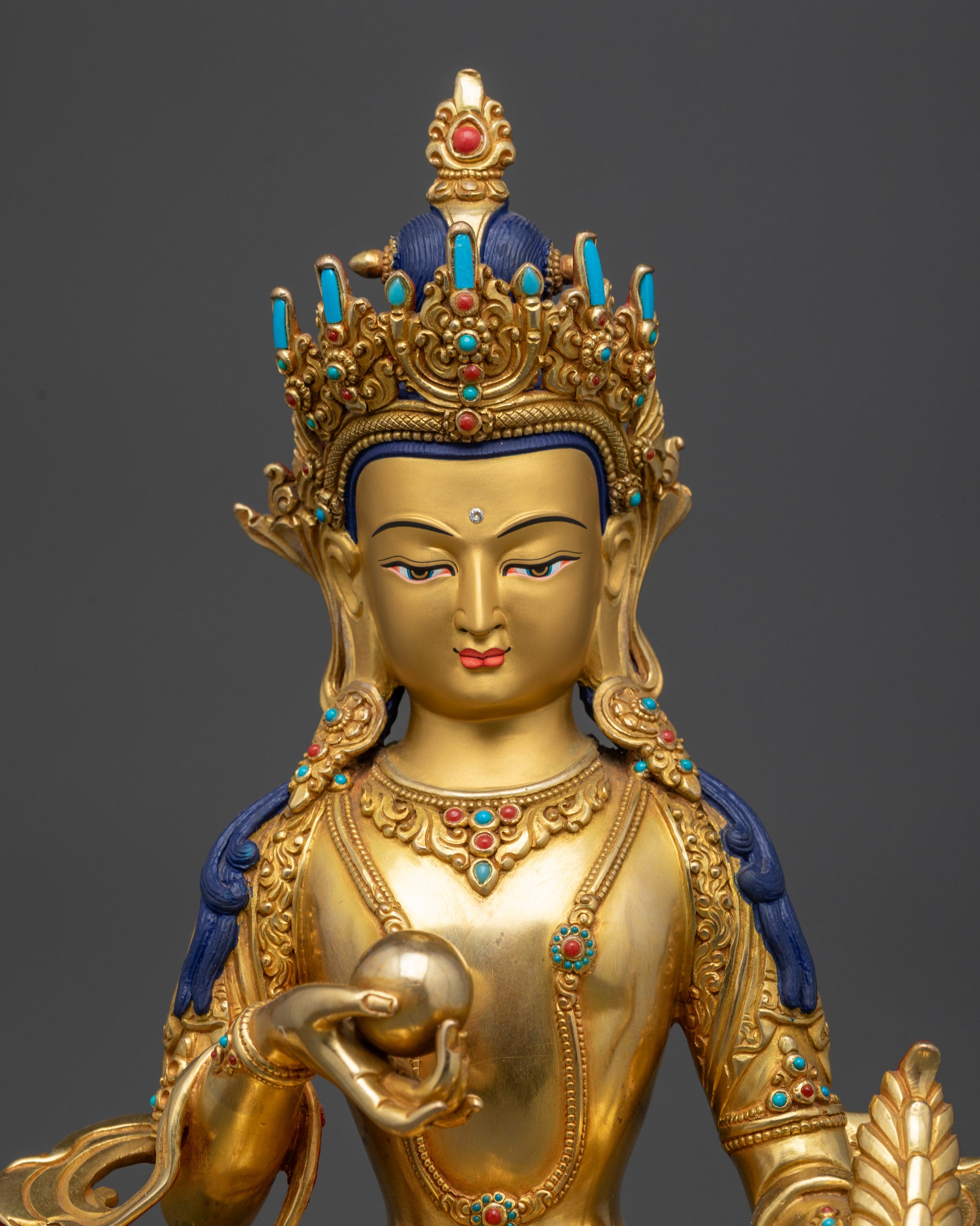 Regular close up of Kshitigarbha Bodhisattva statue showing robe and jewelry details

