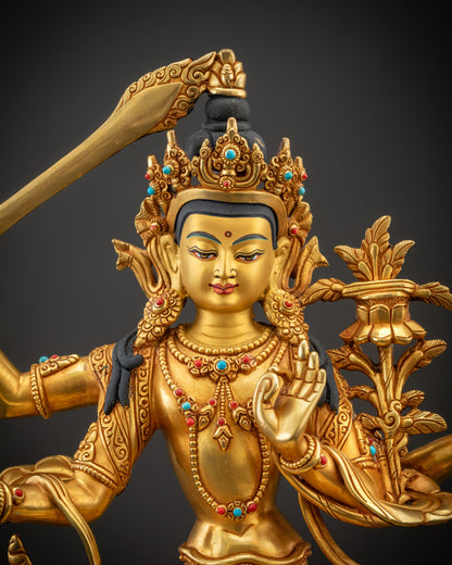 Regular close up of Maha Manjushri statue face highlighting golden warmth and facial details
