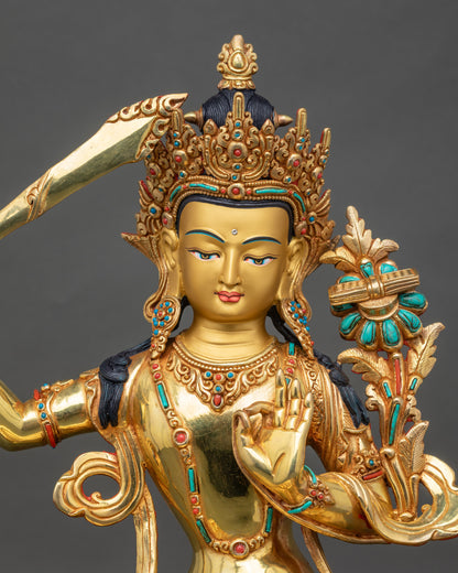 Regular close up of Manjushri Bodhisattva showing intricate robes and gold detailing
