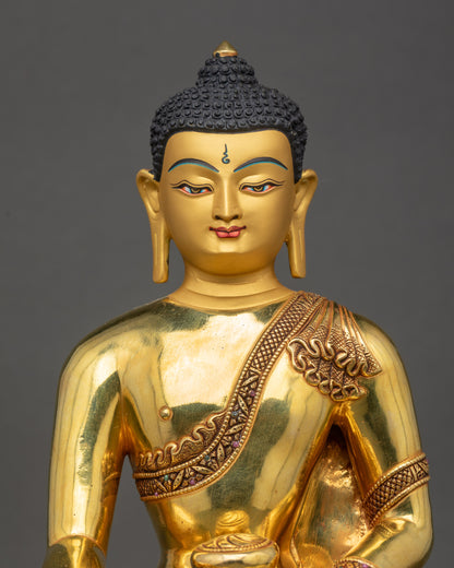 Regular close up of Shakyamuni Buddha Statue showing serene gold-painted face and lotus seat