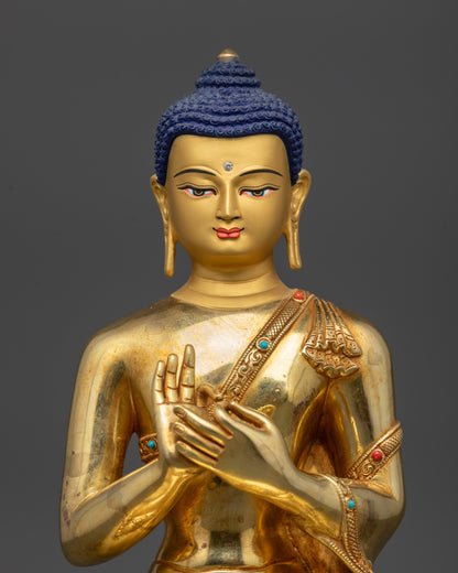 Regular close up of Suvarnabhadra Vimala Buddha statue showing gold-gilded face
