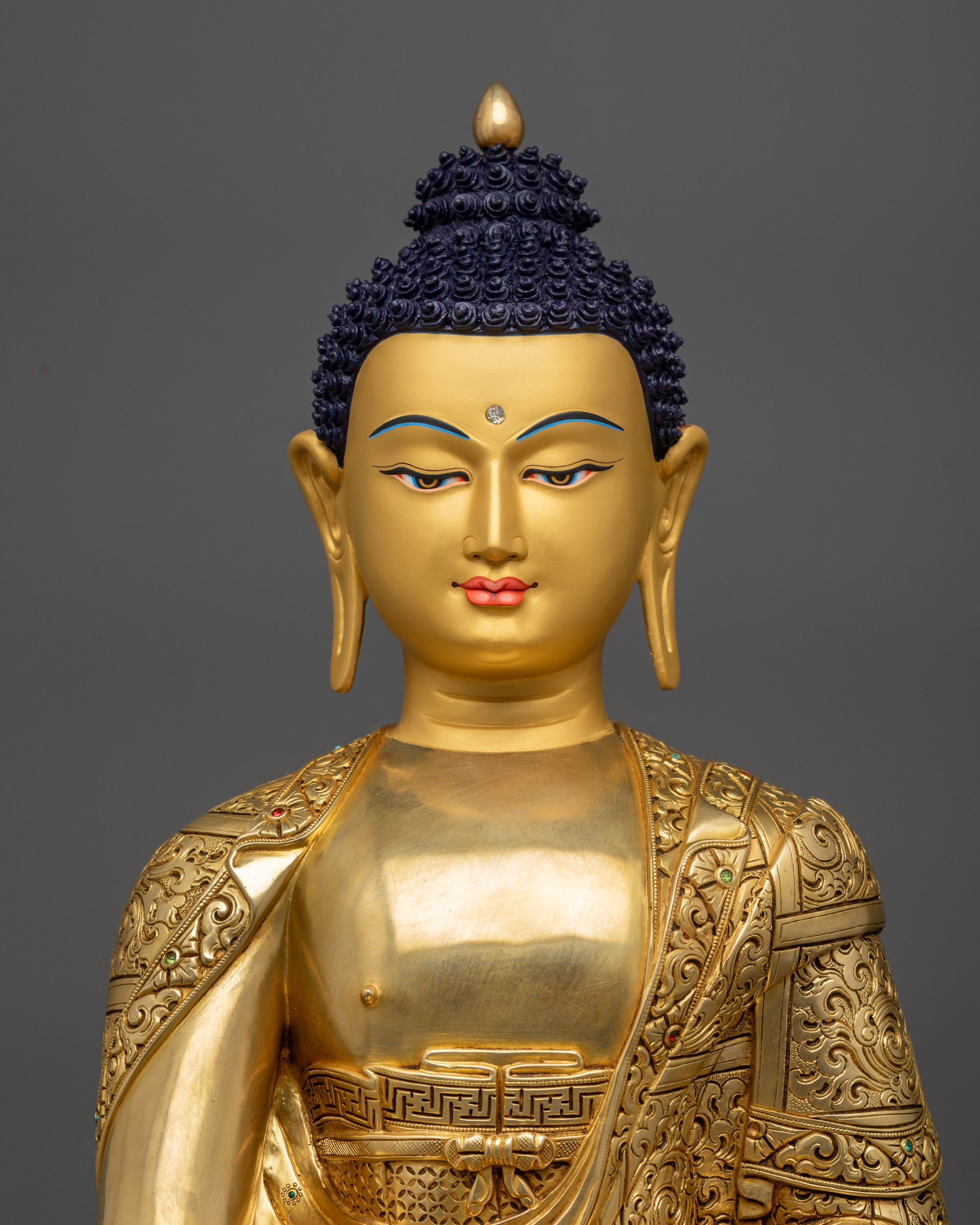 Regular close up of Tathagata Buddha Statue highlighting carved monk garments

