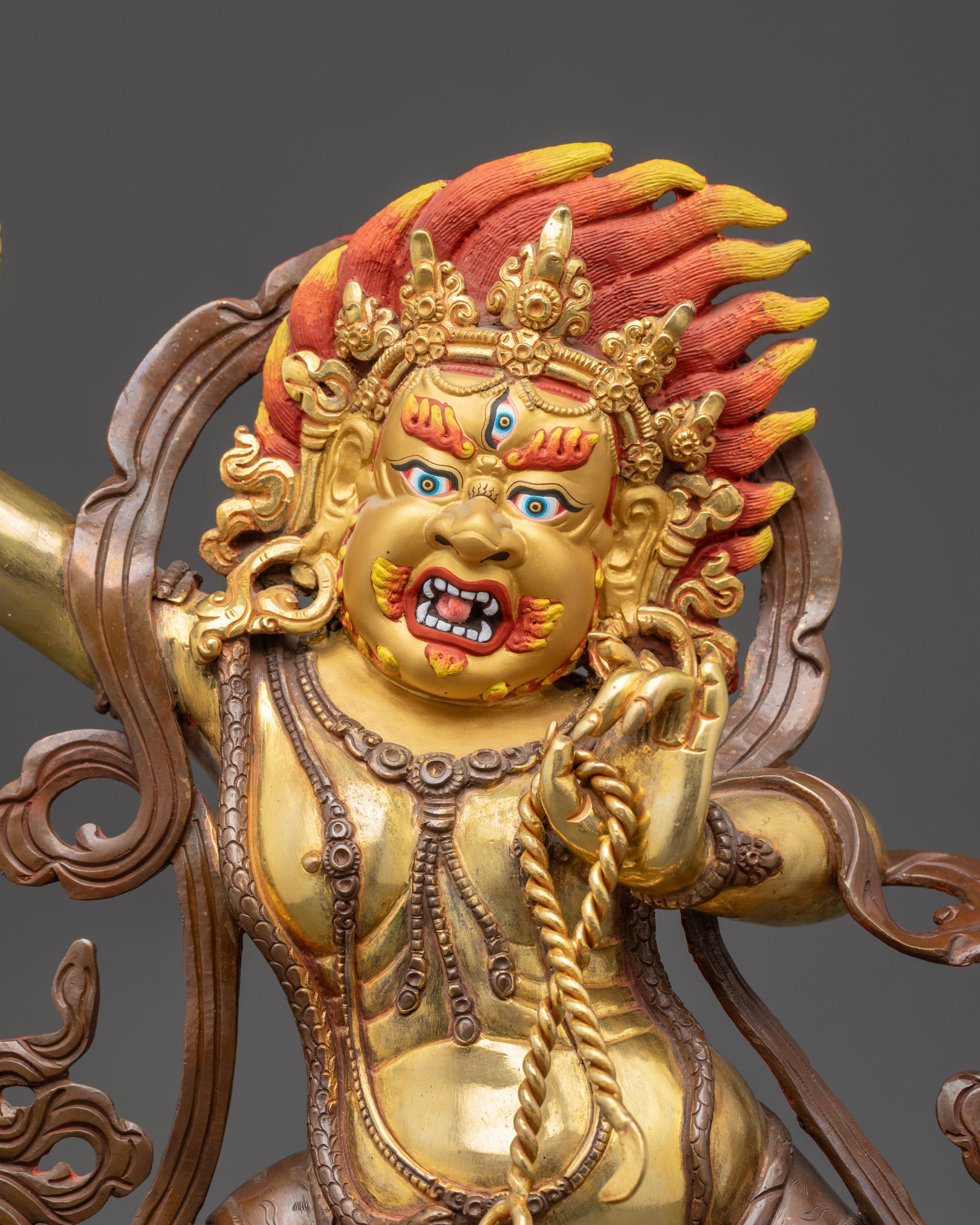 Regular close up of Vajrapani Tibetan protector statue showing vajra and lasso