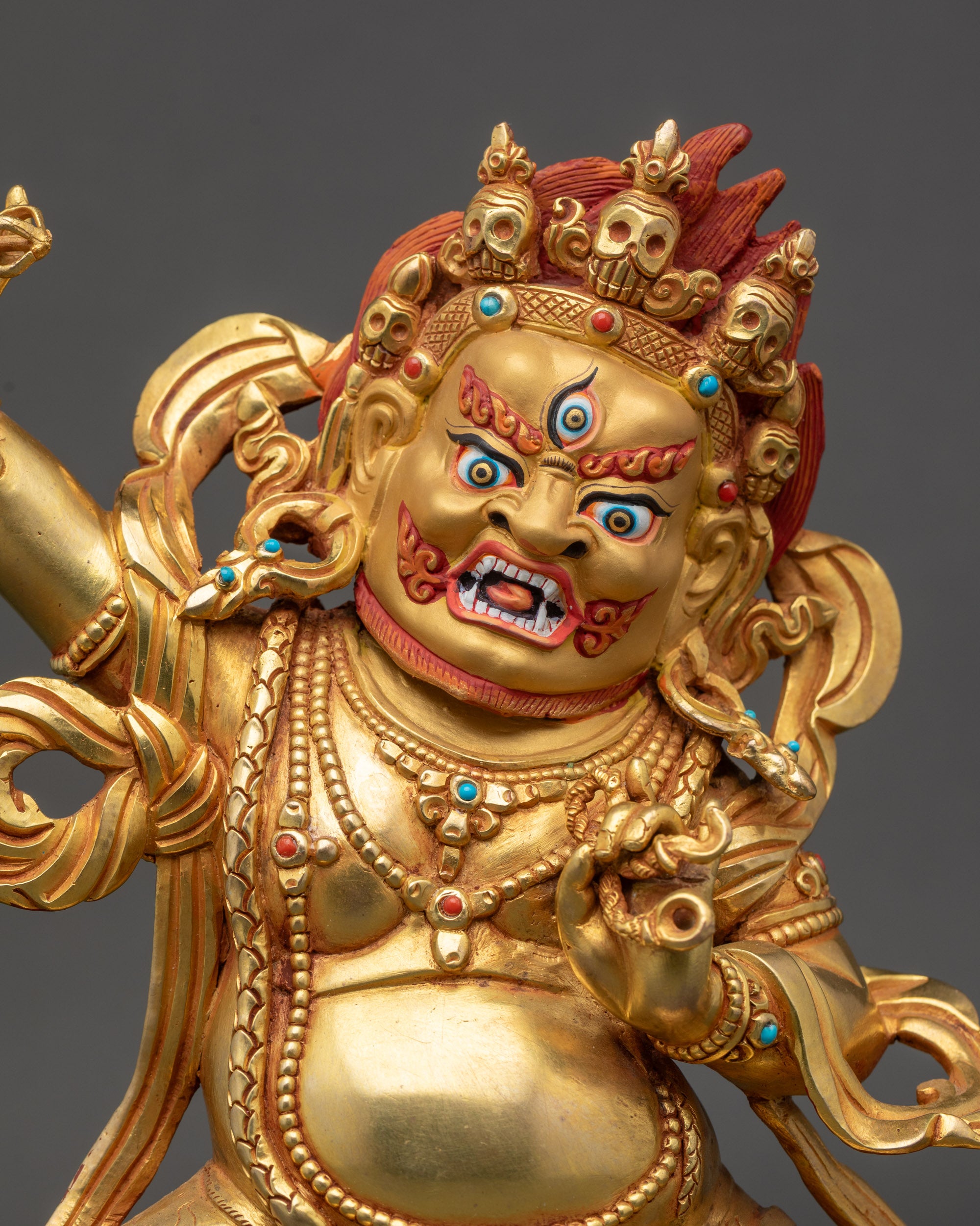 Regular close up of Vajrapani sculpture showing wrathful expression and raised vajra