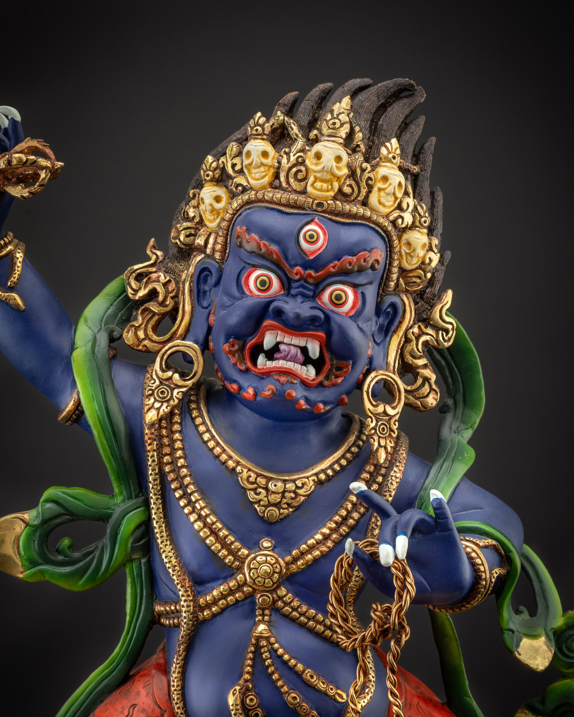Regular close up of Vajrapani statue showing jewelry, robe, and painted details
